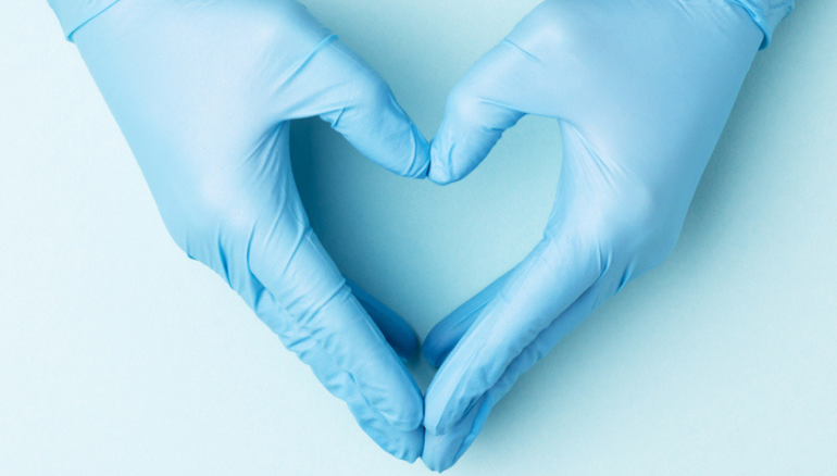 hands in surgical gloves forming a heart