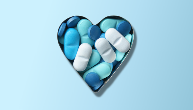 Heart-shaped tin of blue pills on blue gradient background