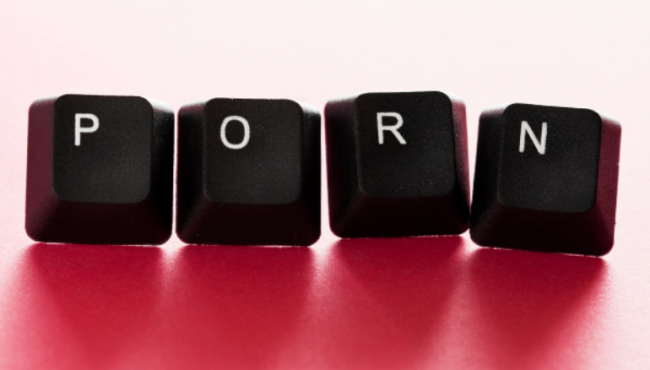 Image of keyboard tiles spelling out 'porn' on pink background